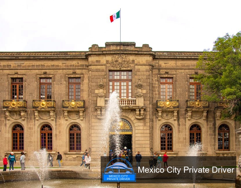 The grand façade of Castillo de Chapultepec with its lush gardens and historical architecture under a clear blue sky.