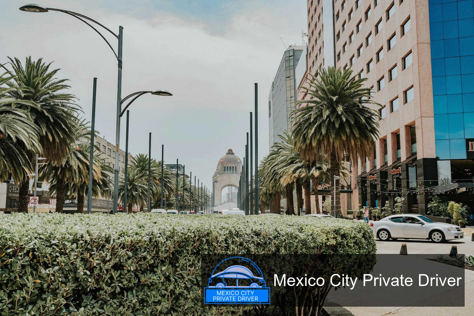 The Monumento a la Revolución illuminated at sunset, showcasing its grand architecture and surrounding park.