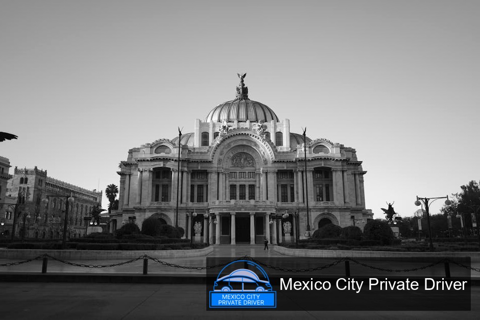 The majestic white marble façade of Palacio de Bellas Artes, showcasing intricate details and vibrant murals under a clear blue sky.