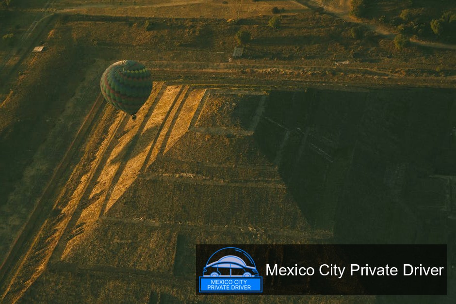 Stunning aerial view of the Pyramid of the Sun and Moon at Teotihuacán, surrounded by lush greenery and ancient pathways.